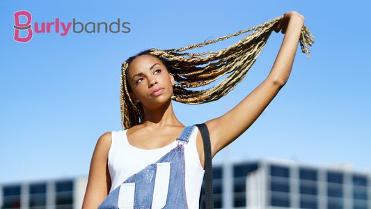 happy woman playing with braids outdoors