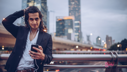 man with long hair in city