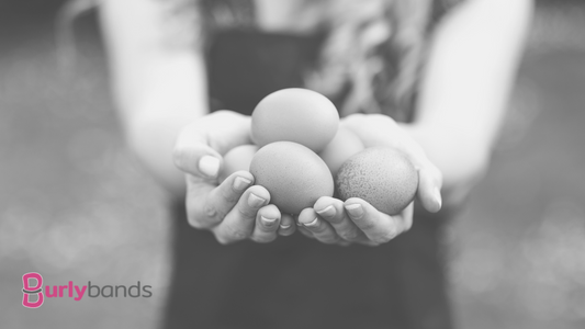 A lady holding out her hand with eggs