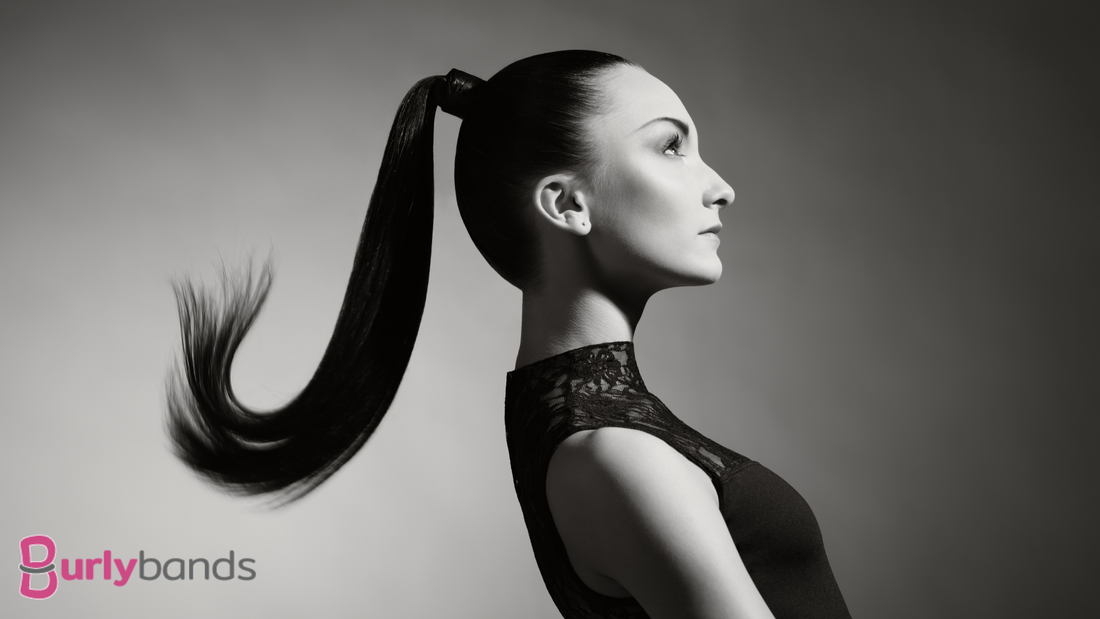 A lady in black and white wearing a high pony tail