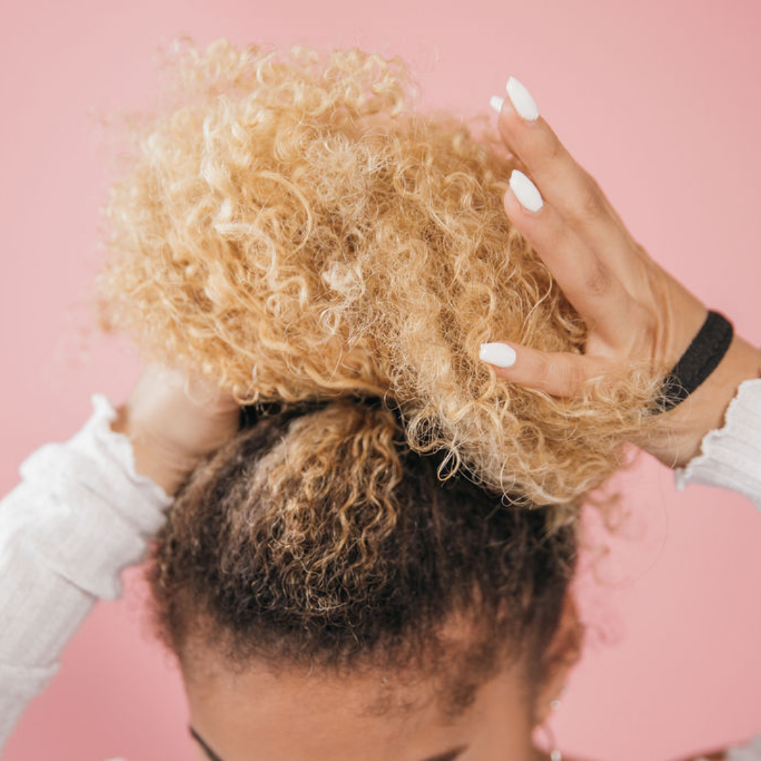 putting on a black hair tie for thick hair