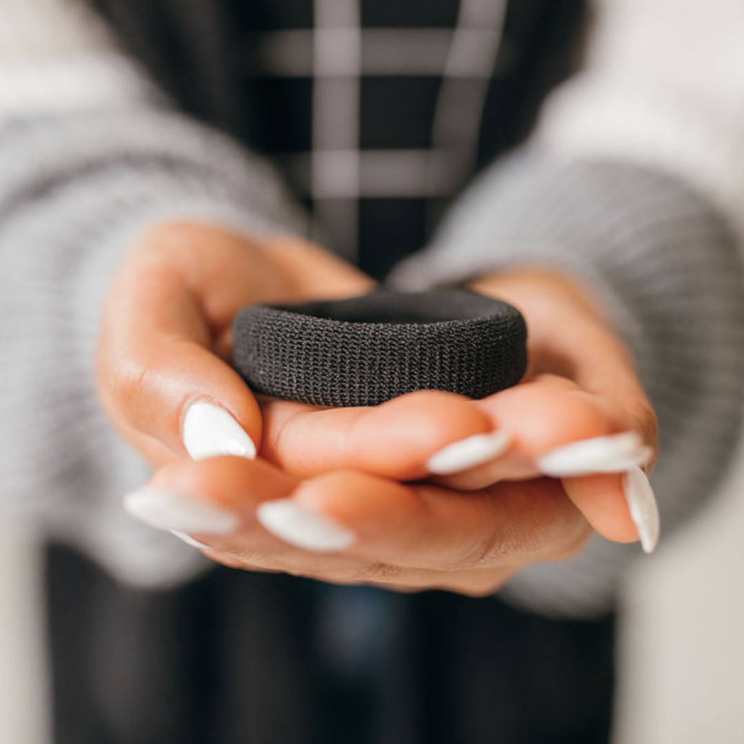 holding a black burlyband with two hands