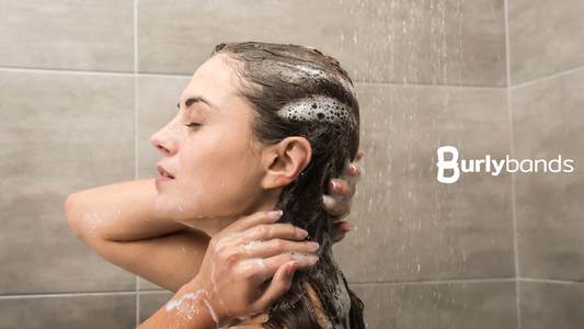 woman rinsing shampoo from hair
