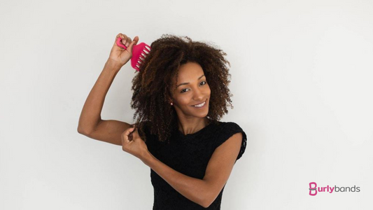 woman brushing hair detangling knots curly hair