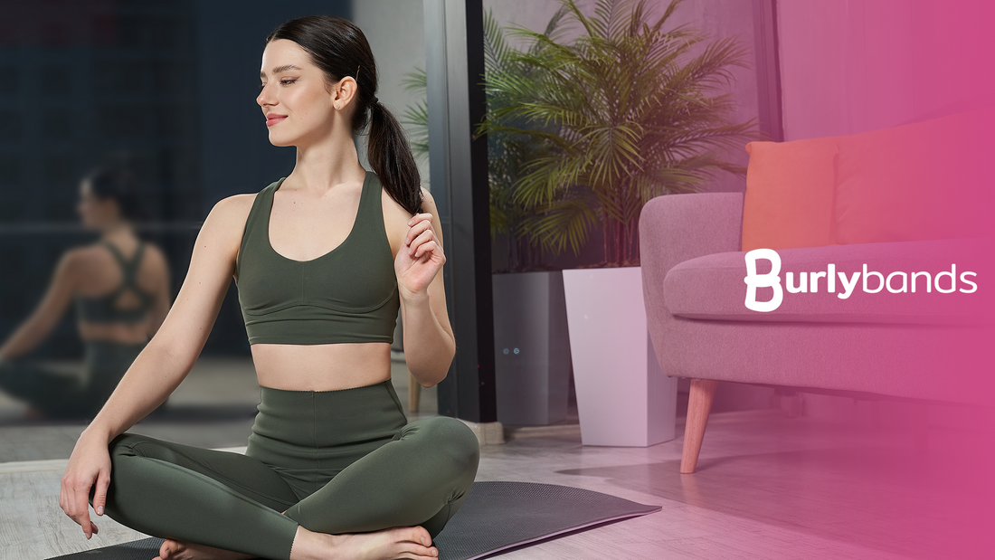 happy woman with workout equipment sitting on yoga mat touching ponytail