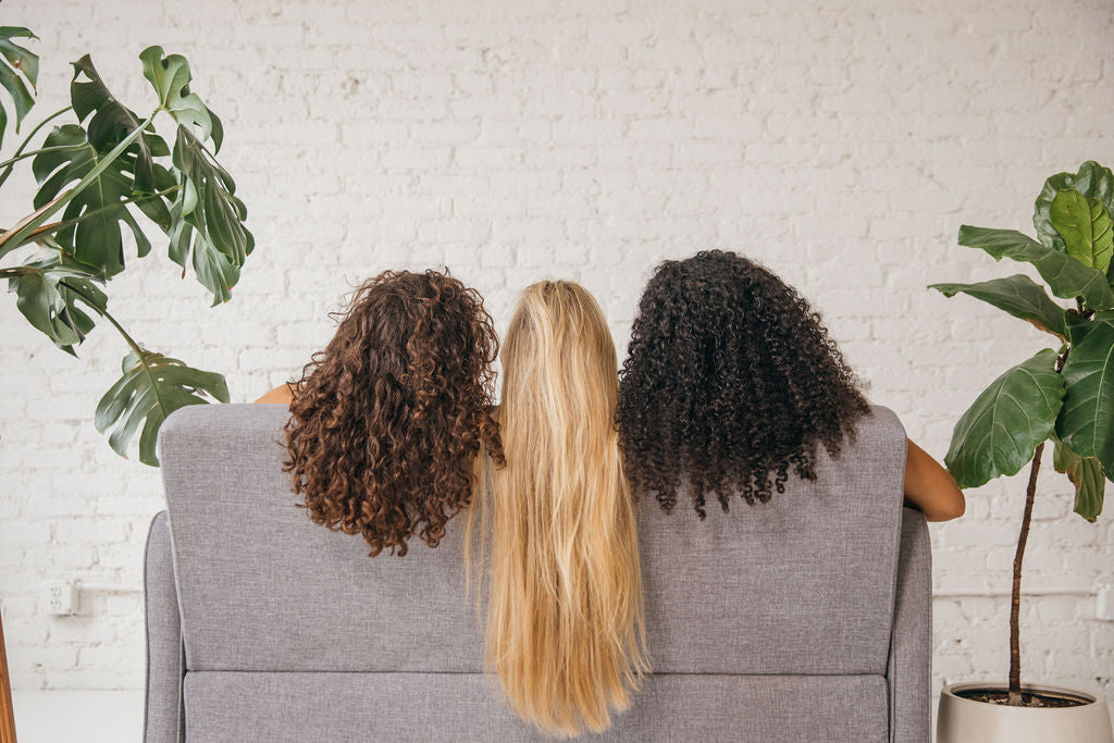 3 burlyband girls sitting on couch with thick hair